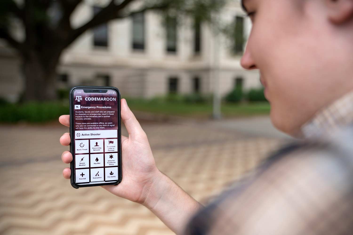 Texas A&M student looking at the code maroon emergency notifications in their Texas A&M app