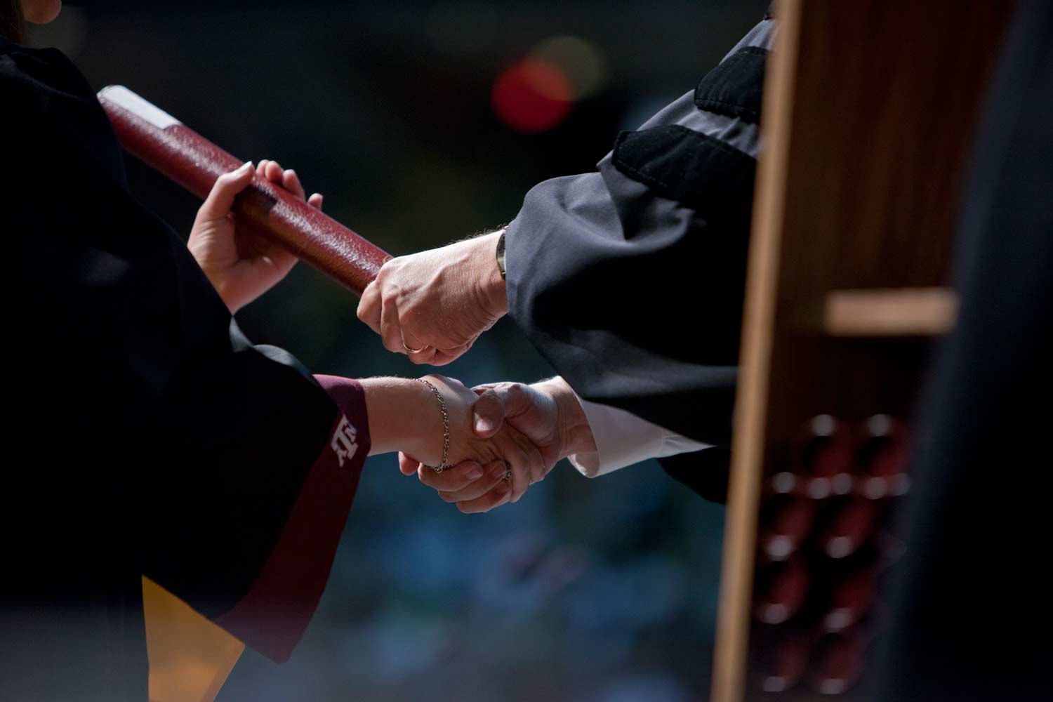 Aggie receives their diploma at graduation