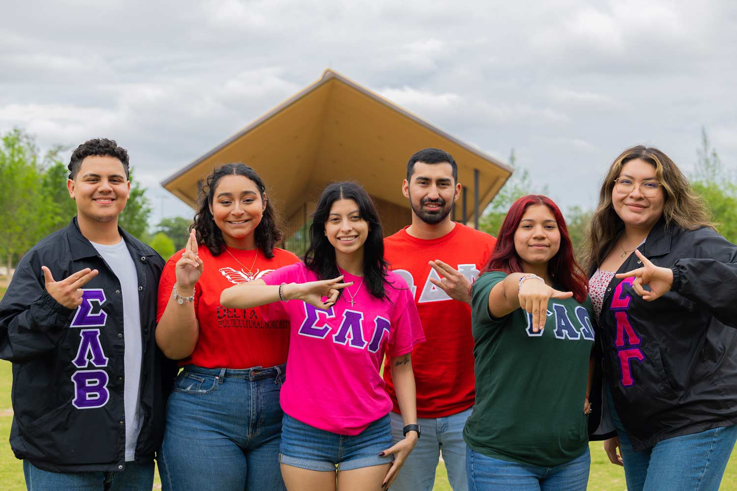 Greek Life student members pose in front of the pavilion at Aggie Park