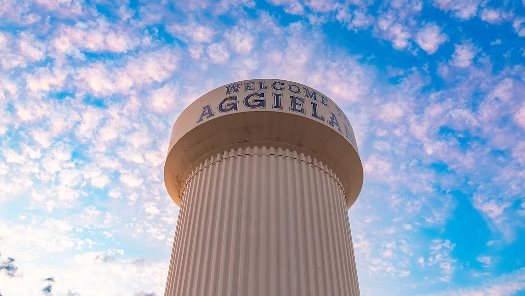 Striking view of the Welcome to Aggieland water tower at sunset